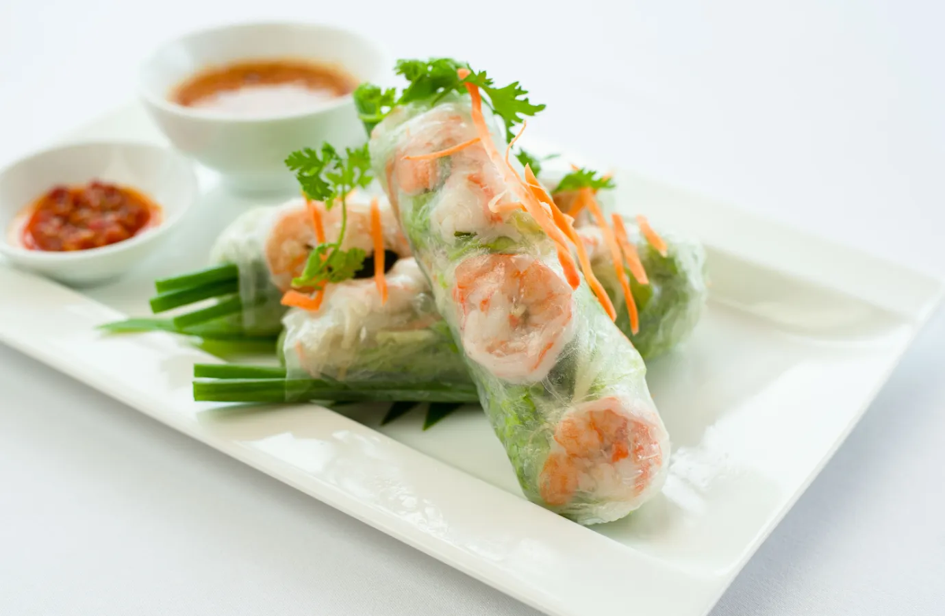 Fresh Vietnamese spring rolls with herbs and shrimp.