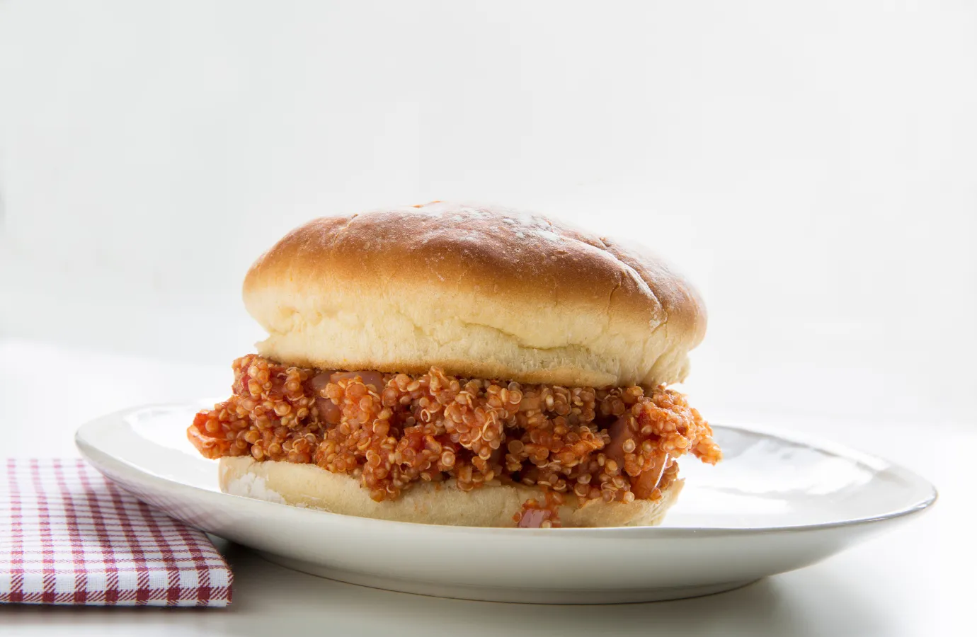 Preparing a Sloppy Joe with Manwich sauce and ground meat.