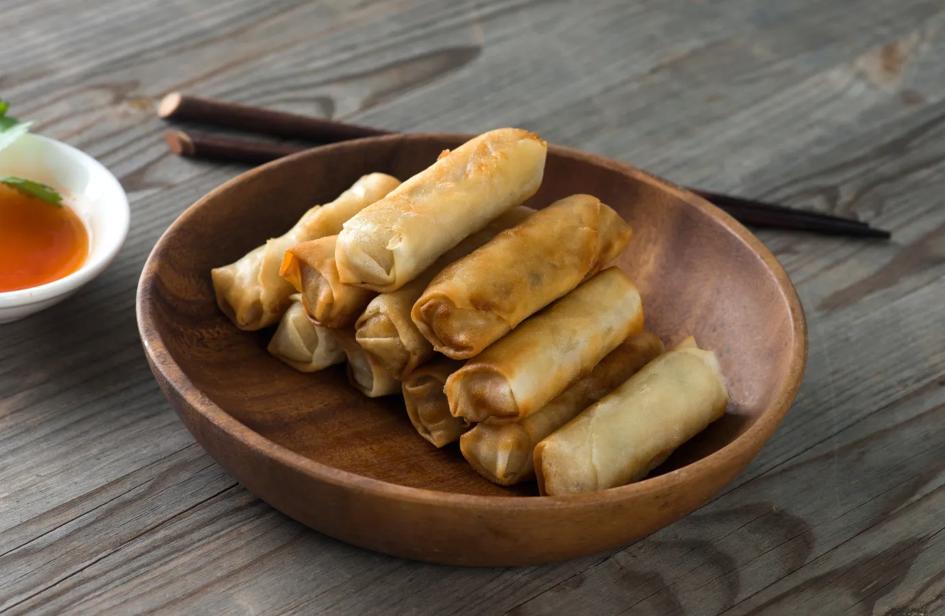 A vibrant platter of assorted Asian spring rolls.