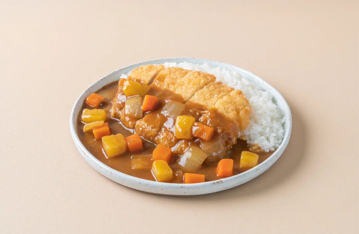 A hearty serving of Japanese curry over rice, showcasing its thick, stew-like consistency.