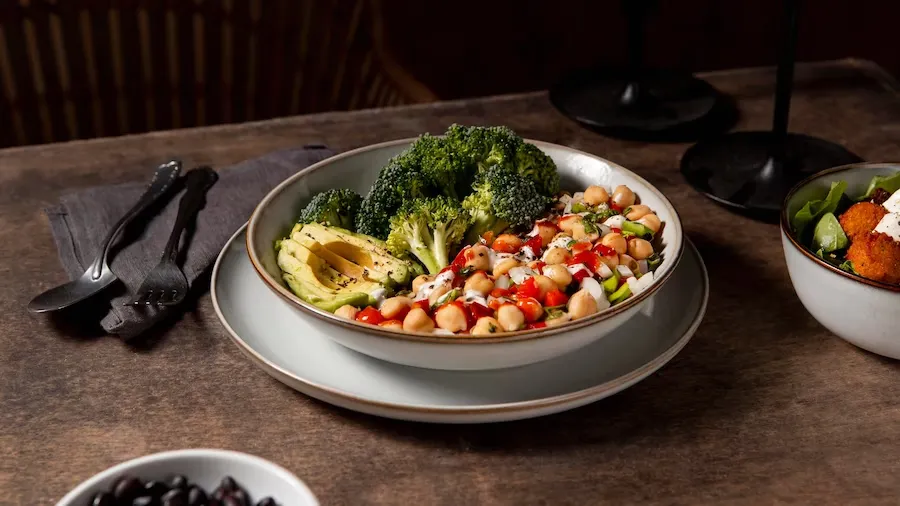 Fresh escarole bean salad with colorful vegetables.