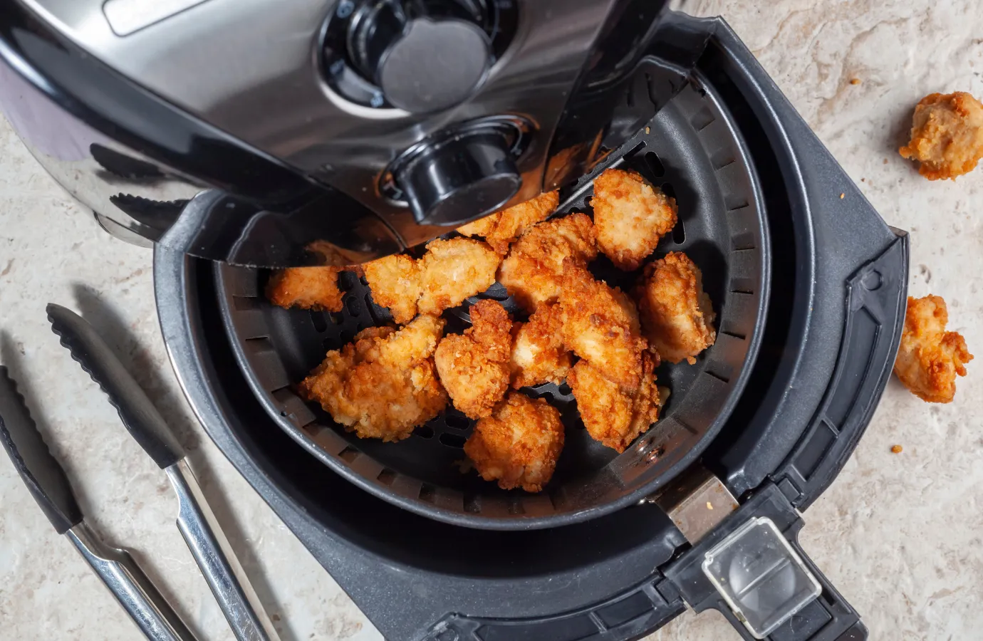  Chicken fries being cooked in an air fryer.