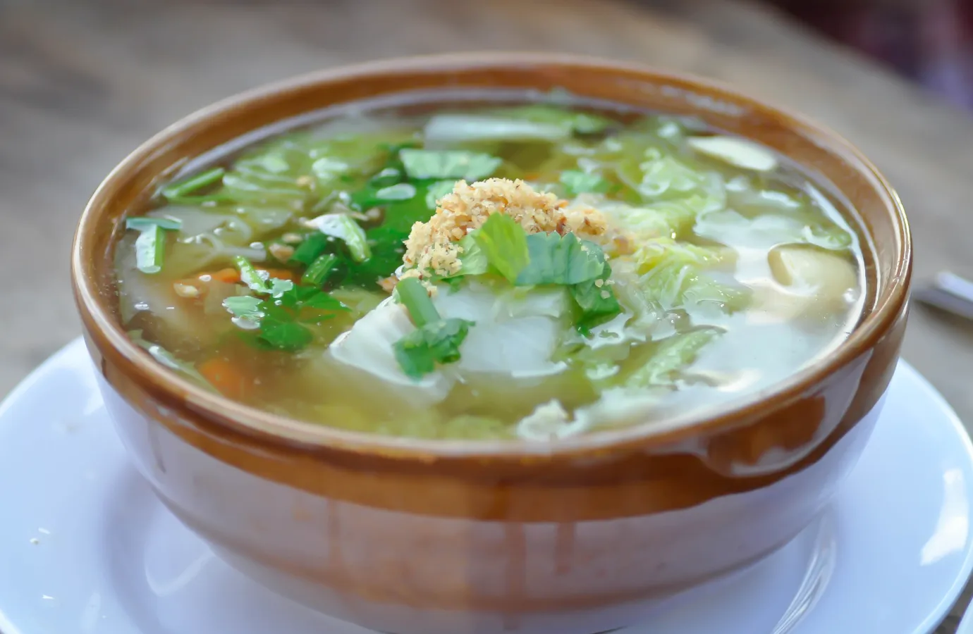 Cooking process of cabbage soup with added herbs and spices