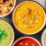 Colorful bowl of vegetable soup with fresh herbs