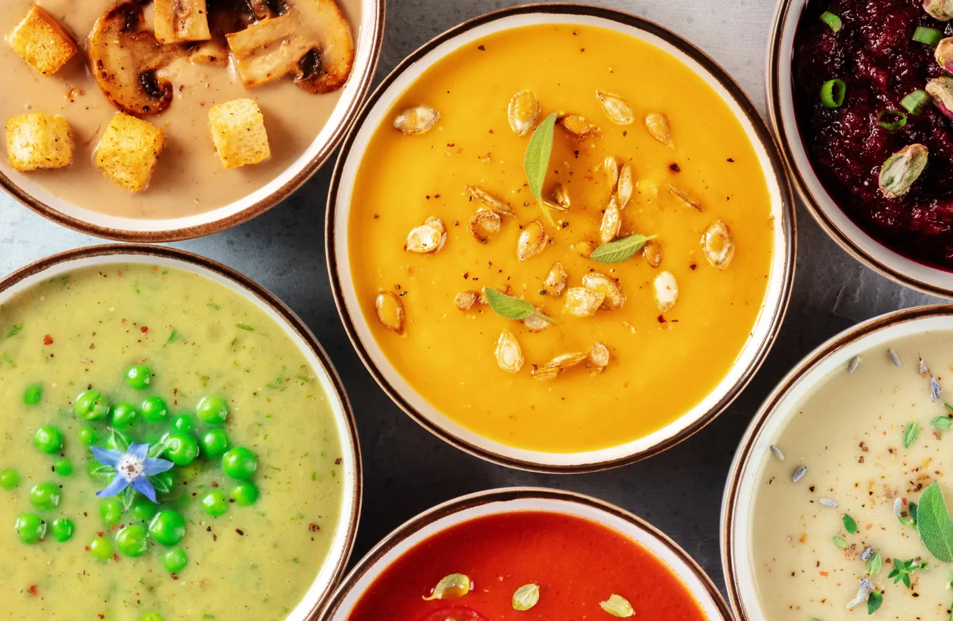 Colorful bowl of vegetable soup with fresh herbs