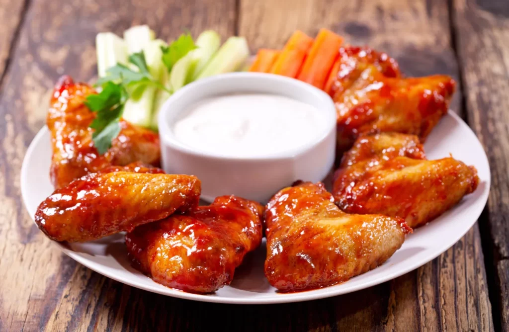 A platter showcasing the fiery Buffalo wings and Nashville hot chicken.