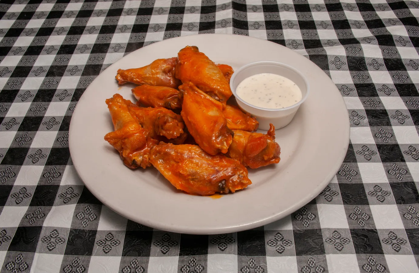 A balanced meal featuring grilled buffalo chicken tenders with side salads and vegetables.